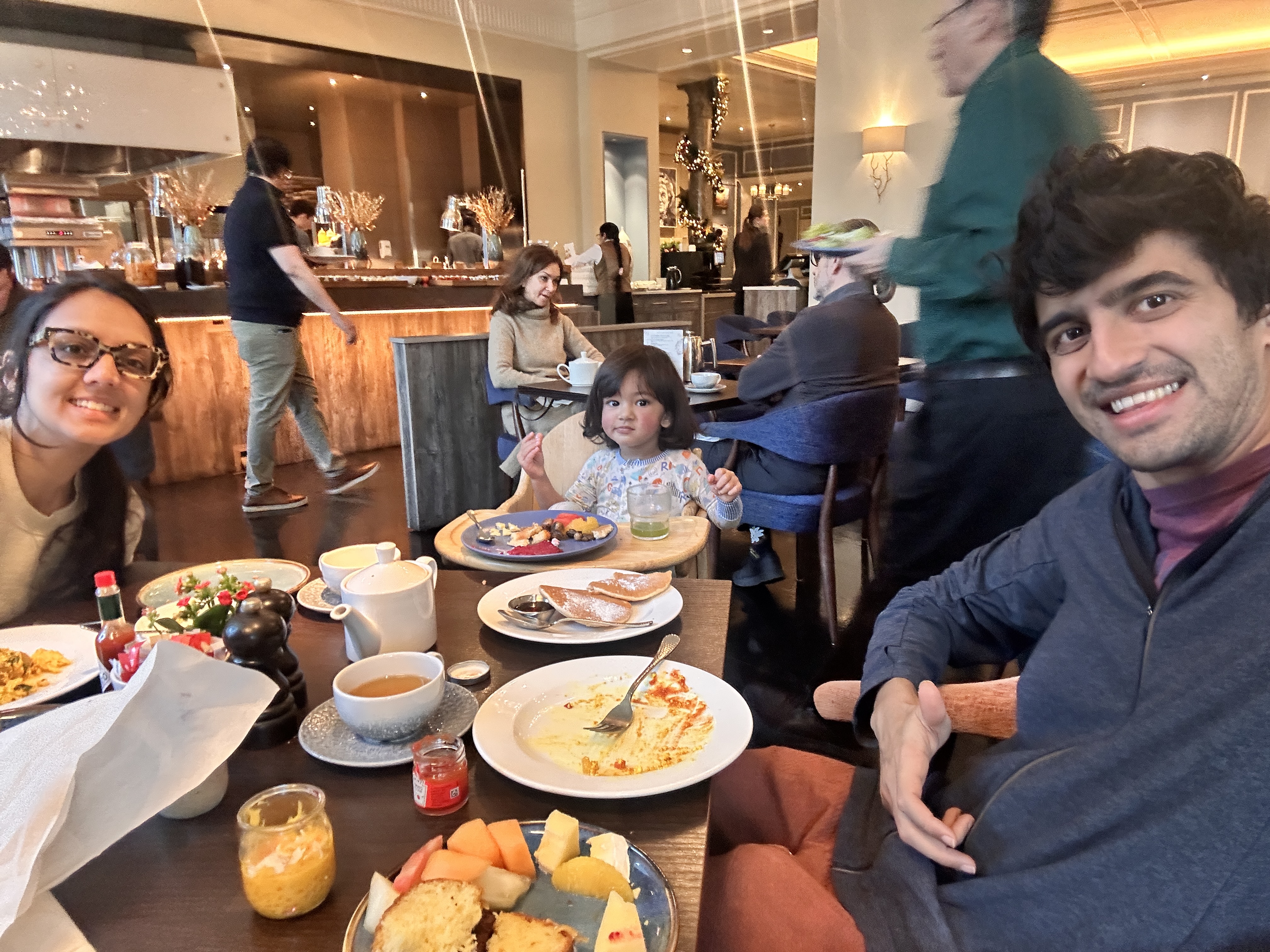 Family breakfast spread with pancakes, fruit, and tea at The Churchill